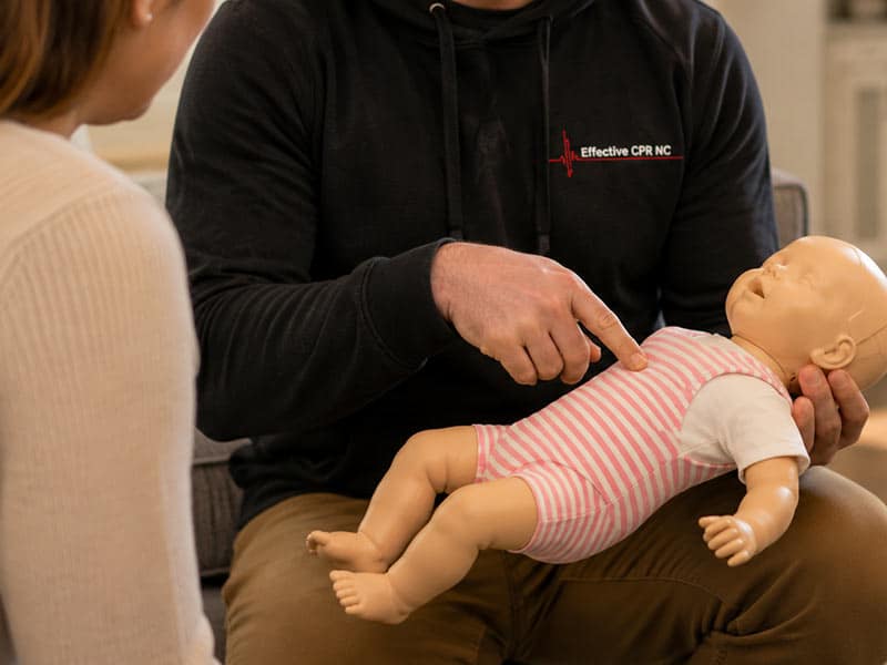 BLS provider skills practice with a manikin and AED trainer in Apex, NC
